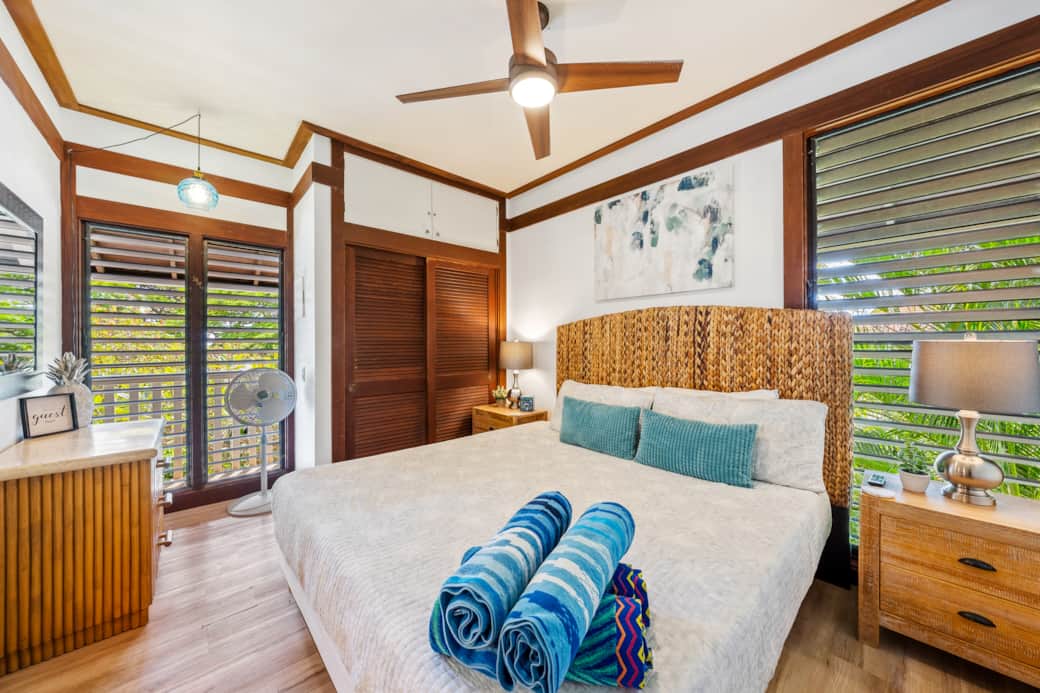 Bedroom w/ Jalousies open - Relax in style and let the gentle breeze from the windows wash over you!