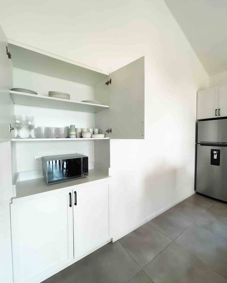 Fridge, microwave, toasted/convection table oven, blender, serving plates, table ware.