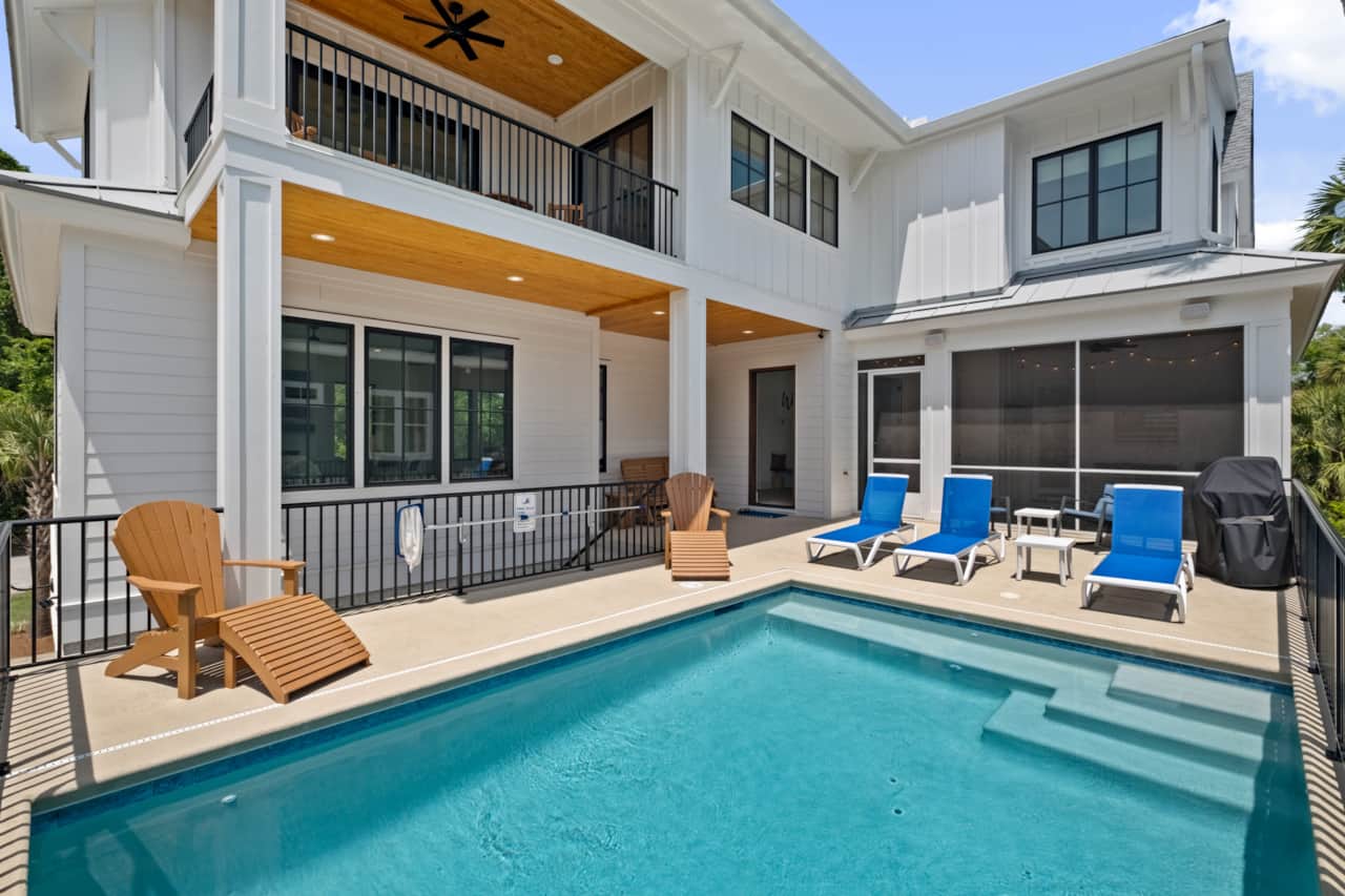 Pool deck with lounge chairs and grill 