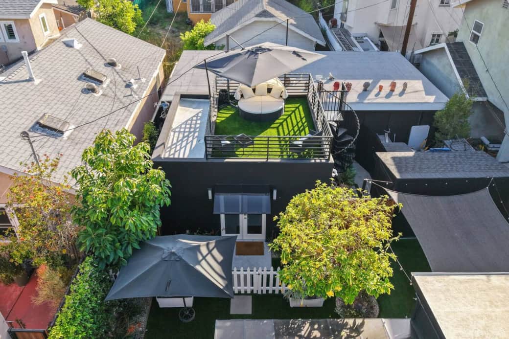 Aerial view showcasing the private yard, patio seating, and rooftop lounge setup. Aerial view showcasing the private yard, patio seating, and rooftop lounge setup.