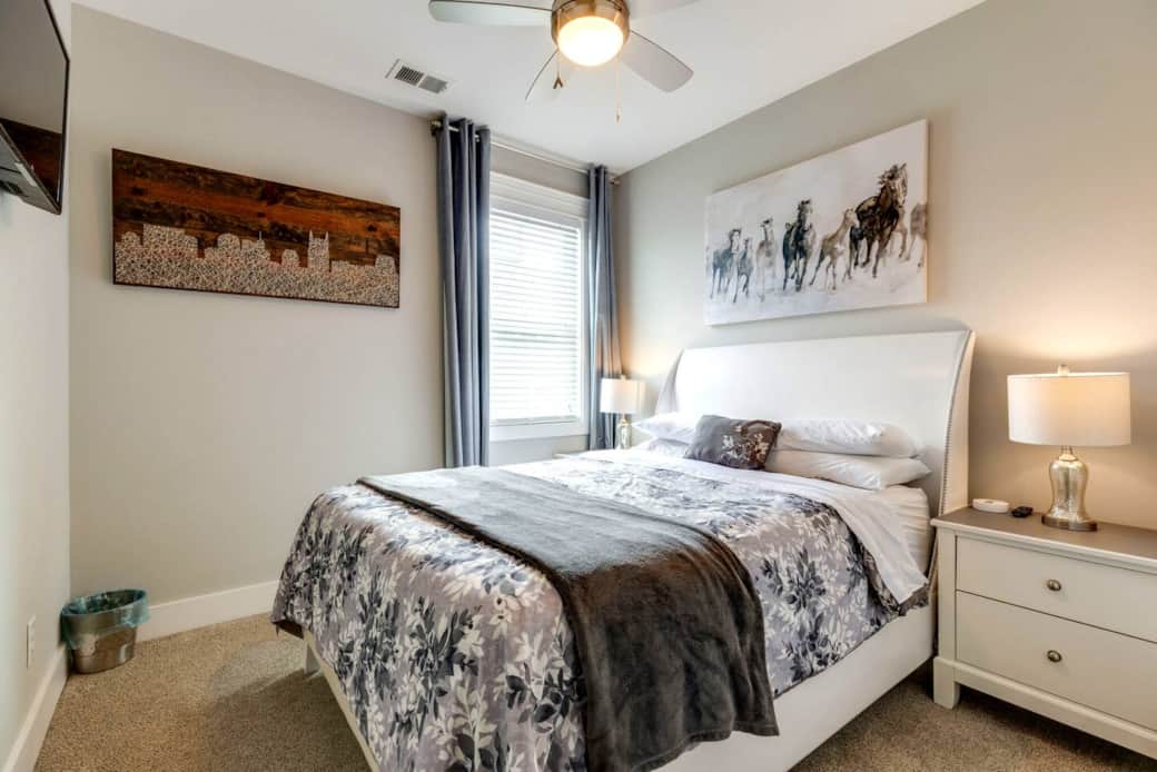 Comfortable queen bedroom with soft bedding and plenty of natural light.