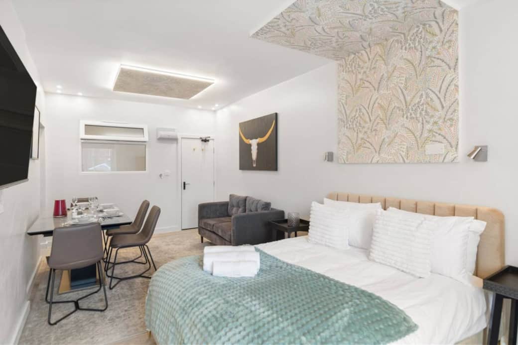 A modern dining space with a sleek table set for four, perfect for shared meals. A modern dining space with a sleek table set for four, perfect for shared meals.