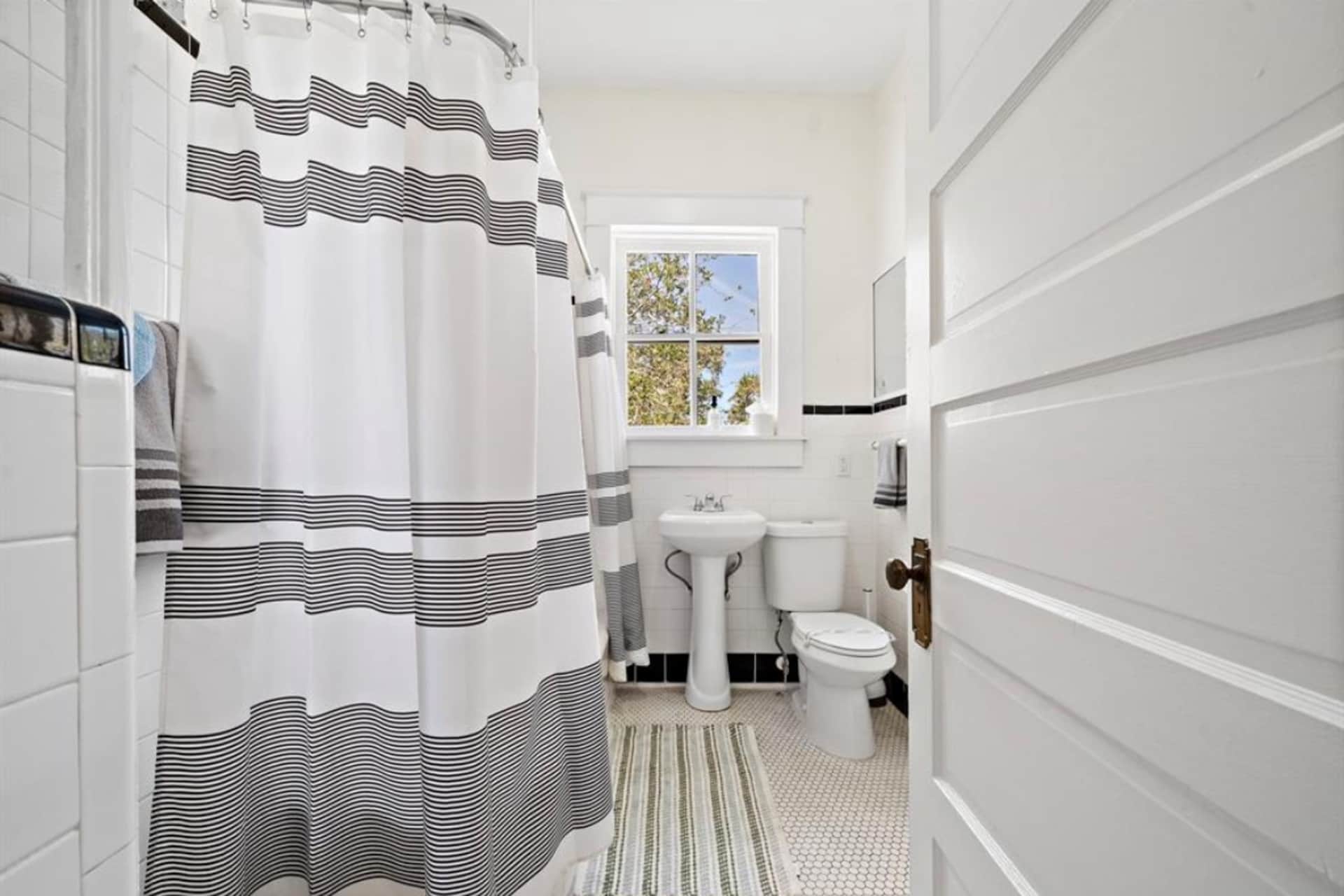 Full bathroom with bath and shower combo.