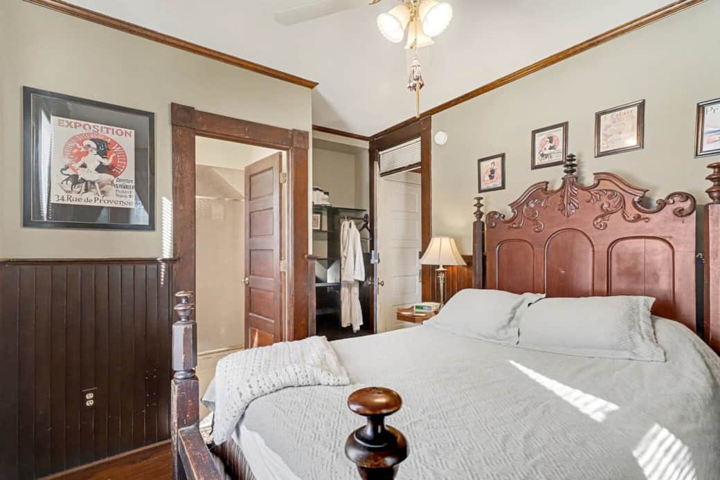 Queen-size bed on antique, solid wood frame with craftmanship details.