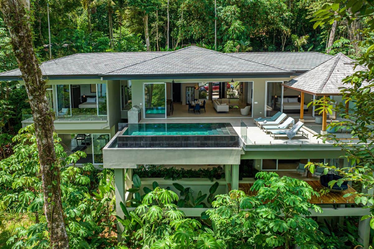 View from the ocean of Villa Sueño's modern architecture surrounded by tropical jungle.