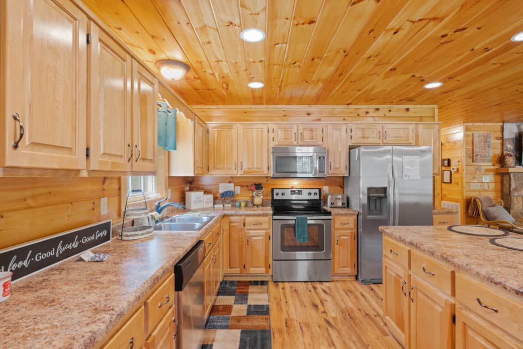 Spacious kitchen w/hand-crafted birch cabinetry & stainless appliances.