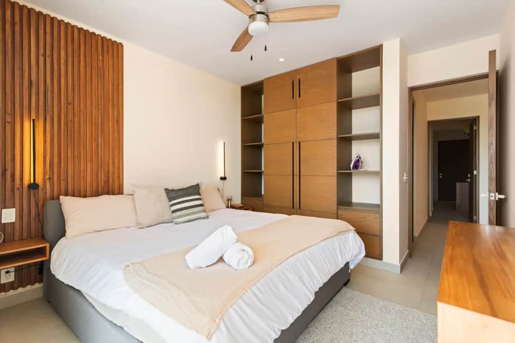 King-size bed, spacious wardrobe, ceiling fan, AC, and iron for convenience.