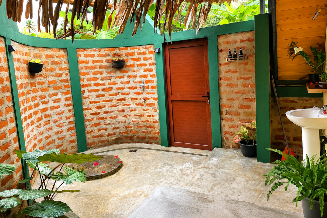 Private open-air bathroom surrounded by tropical greenery