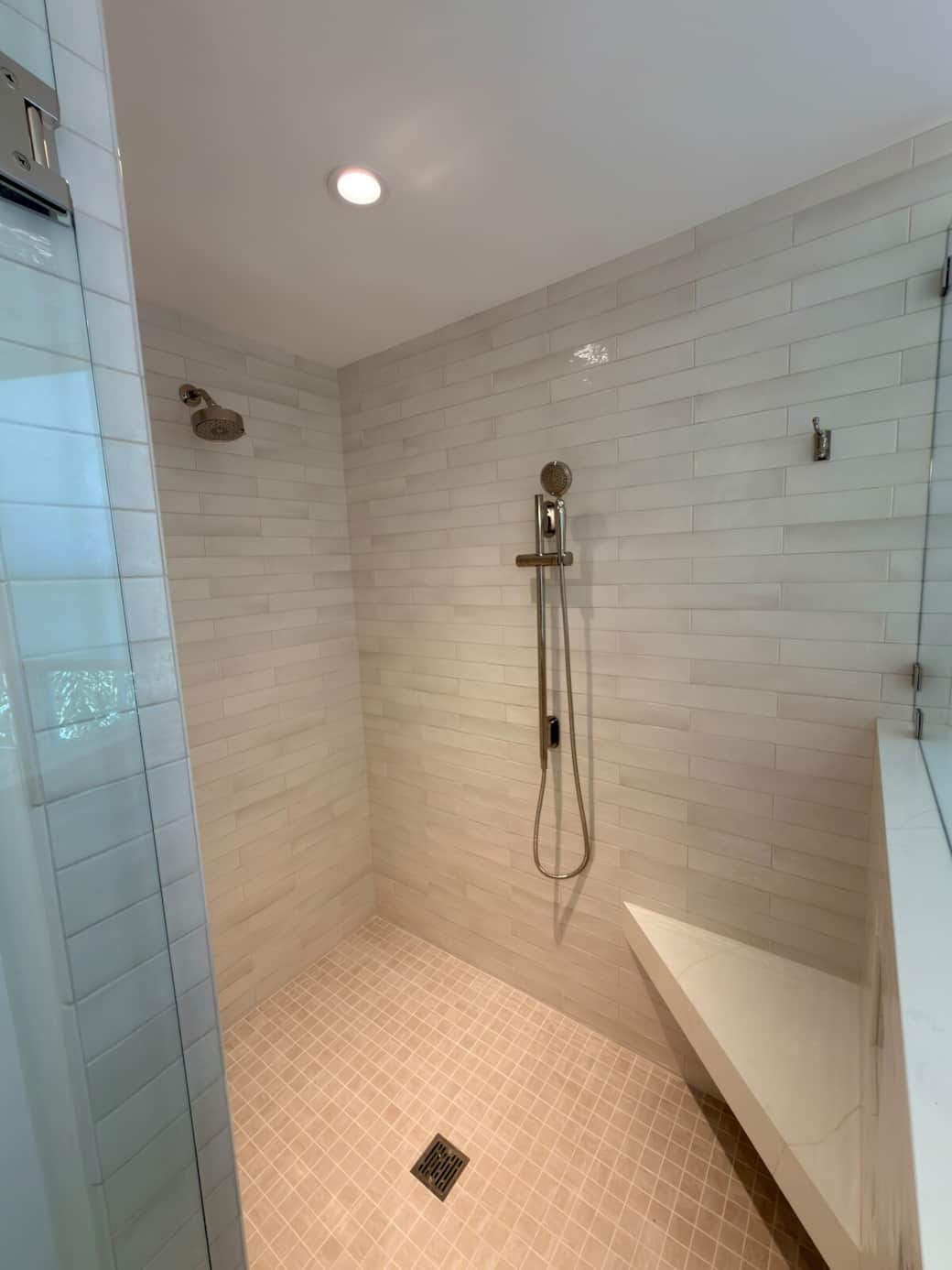 A spacious, spa-like en-suite bath featuring a walk-in shower, soaking tub, and his and hers vanity. Finished in a refined coastal-modern style, it offers a bright, luxurious setting designed for comfort, relaxation, and privacy.