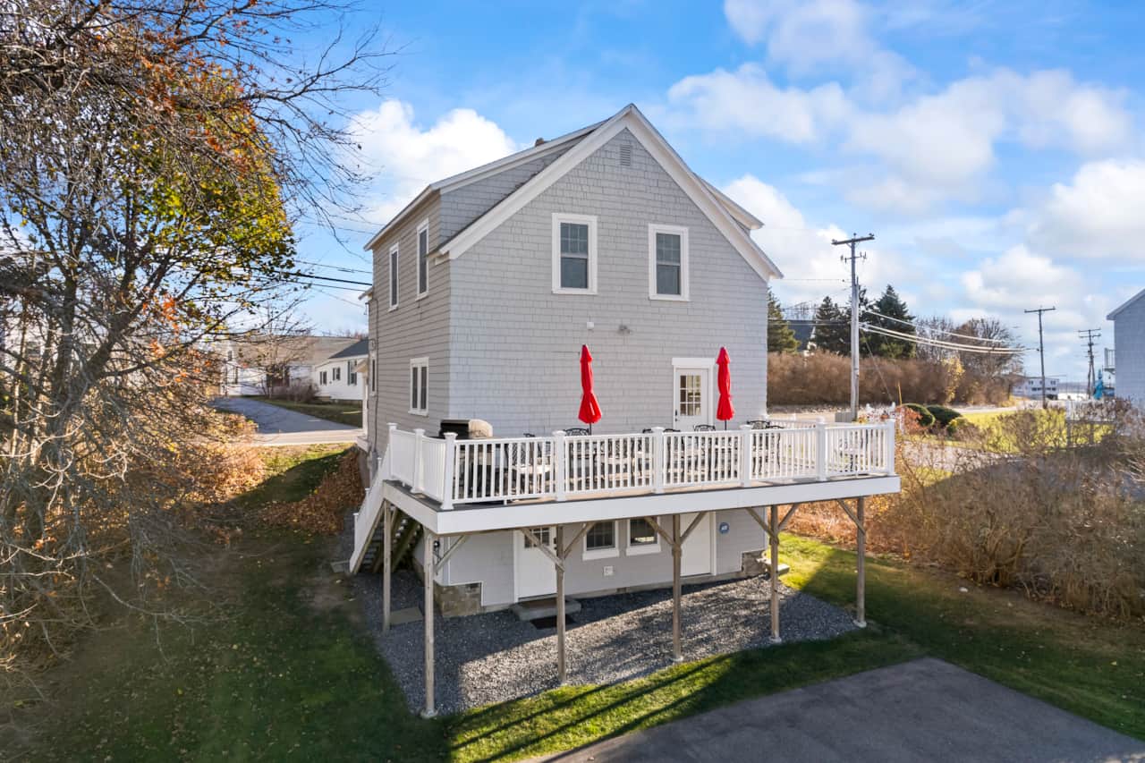 Large back deck with eating area and grill