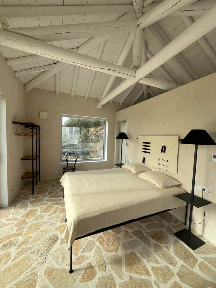 This view captures the bedroom from the East-facing window, directly opposite the western one, allowing natural light to flow in throughout the space from dawn to dusk.