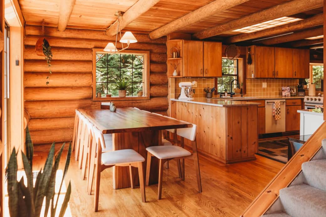 A live edge wood dining table set up for 10 guests with 2 extra chairs to seat up to 12. A Stokke high chair is also stored in the laundry room. A live edge wood dining table set up for 10 guests with 2 extra chairs to seat up to 12. A Stokke high chair is also stored in the laundry room.