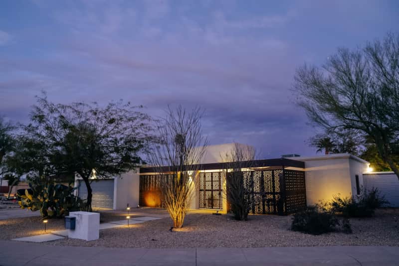 Front exterior showing the driveway, attached garage and landscaped entrance.