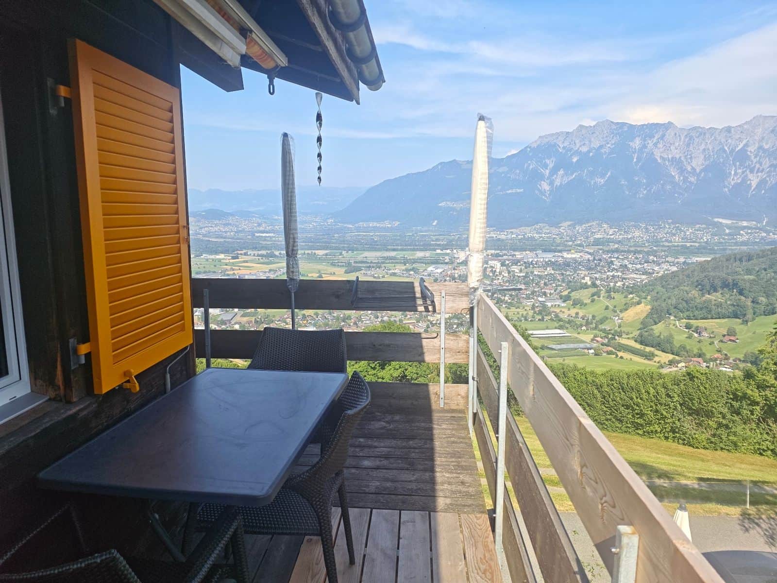 Private balcony with dining table and wide mountain views