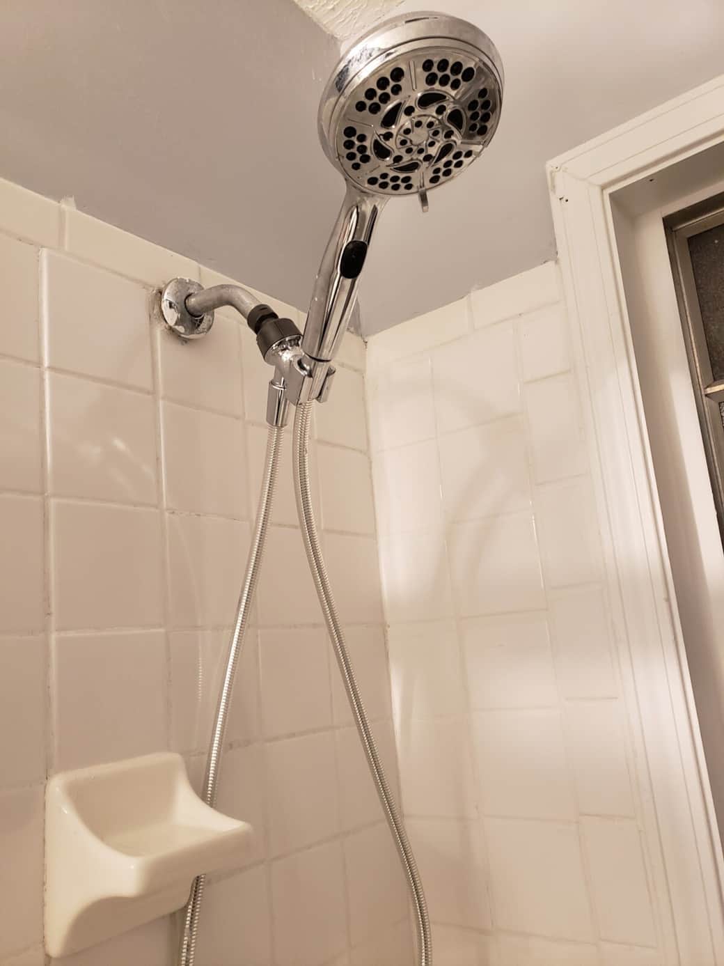 Stainless steel oversized handheld shower head with multiple spray patterns.