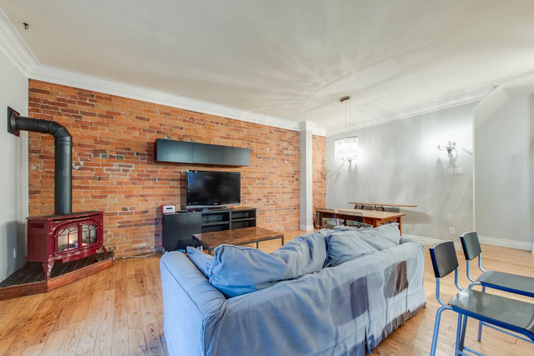 Chic dining area in a short-term rental, with stylish decor. and a fire place.