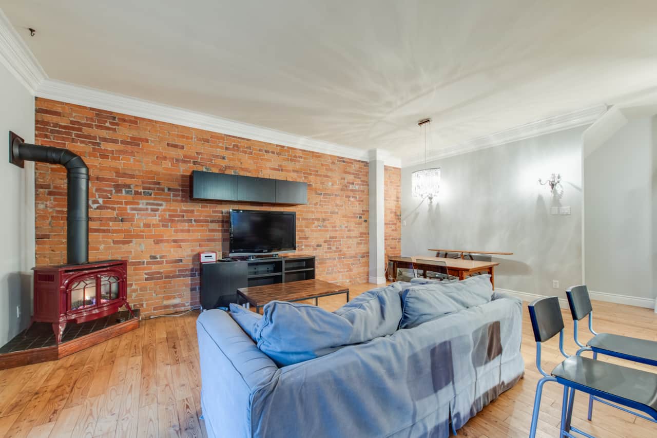 Chic dining area in a short-term rental, with stylish decor. and a fire place.