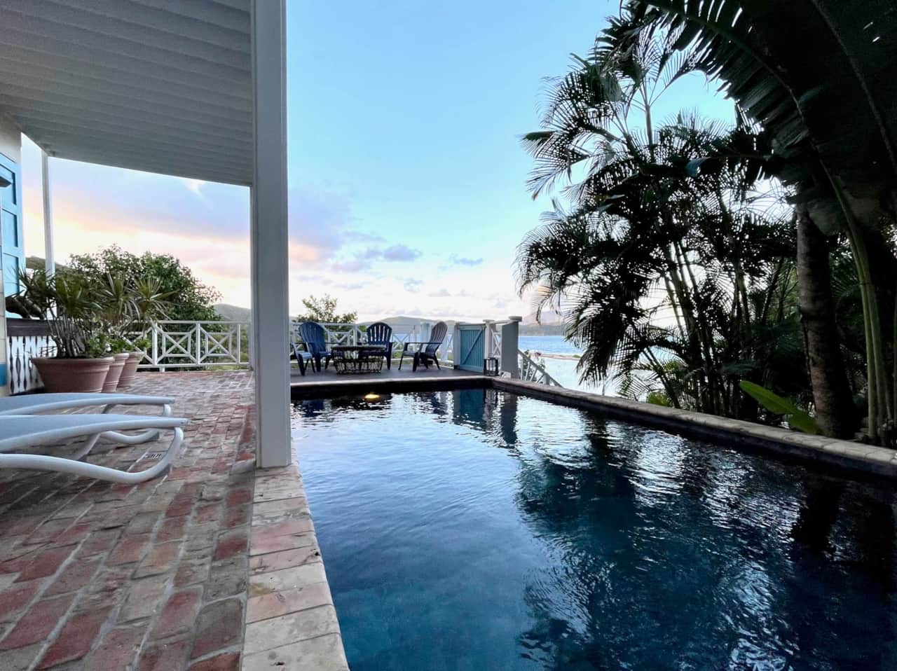 Pool deck surrounded by lush landscaping