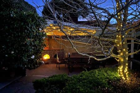 Private and sheltered back yard with outdoor fireplace Private and sheltered back yard with outdoor fireplace