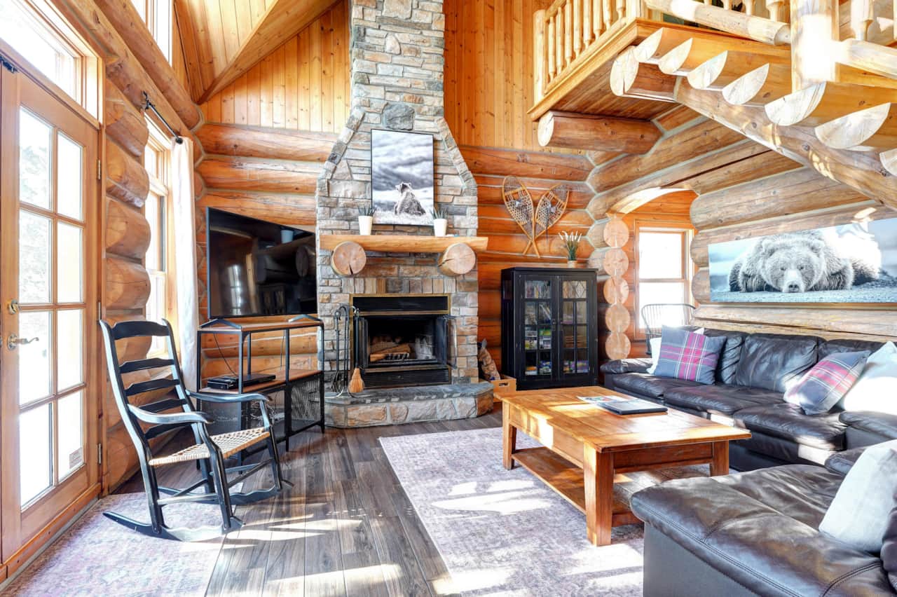 Cozy living room with rocking chair and stone fireplace