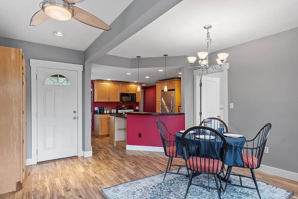 Looking from screen porch into dining/kitchen and side entry door.