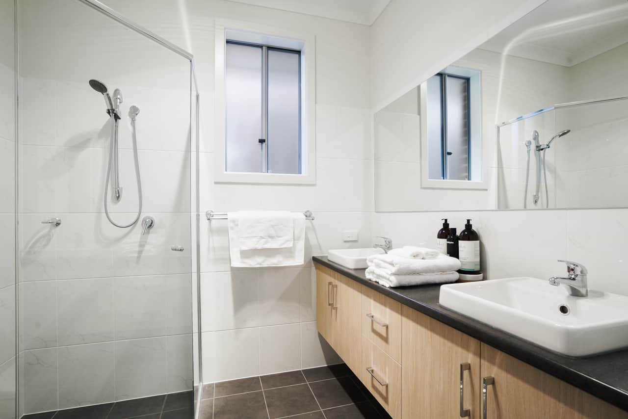 Ensuite indulgence: Double basins, chic corner shower. Spa-like luxury meets contemporary design. 