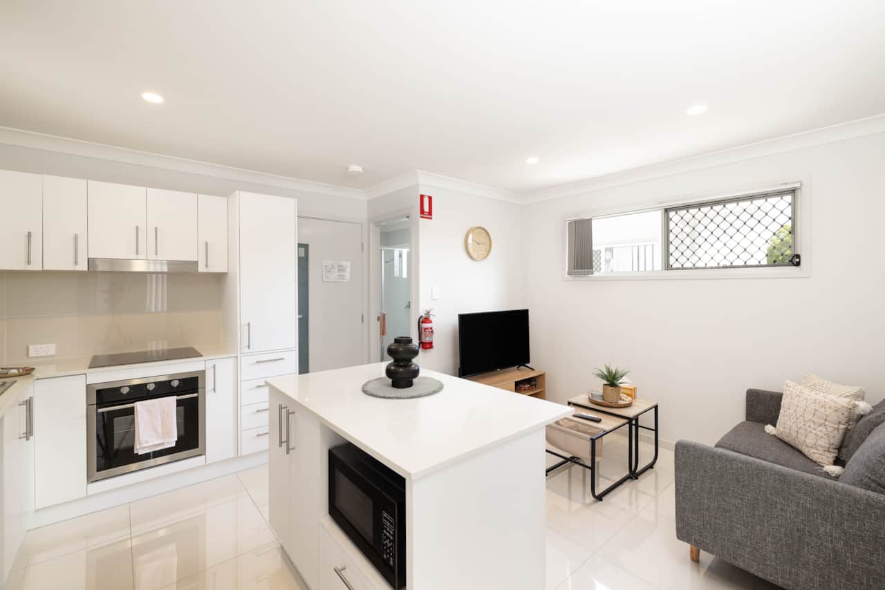 Living Area: Bright living space with comfortable seating and TV 
