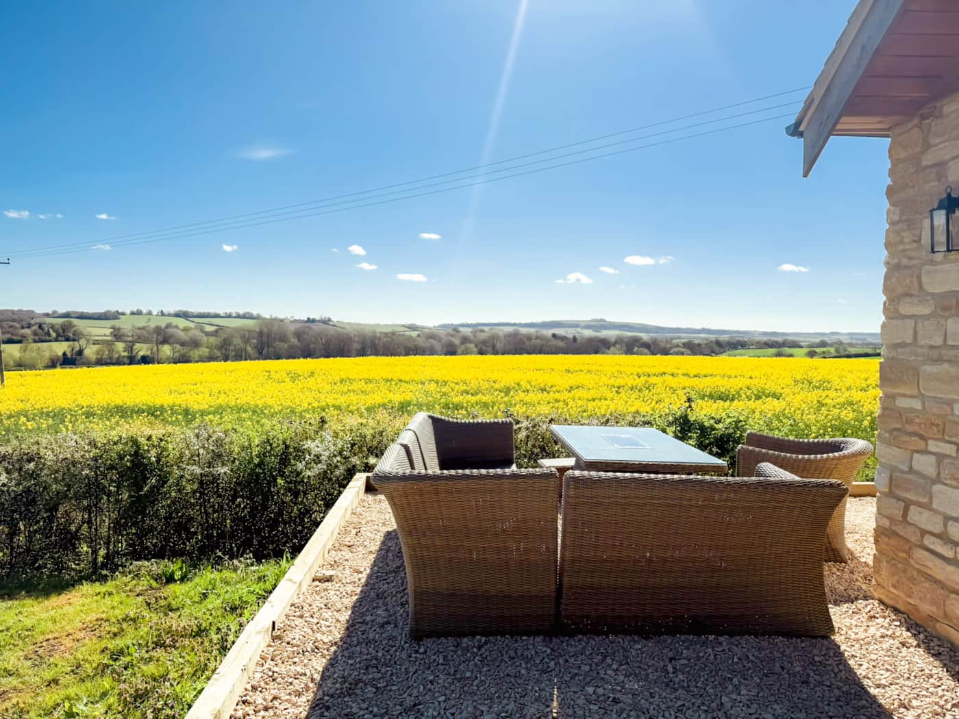 Terrace seating at The Cotswold Barn with open countryside beyond