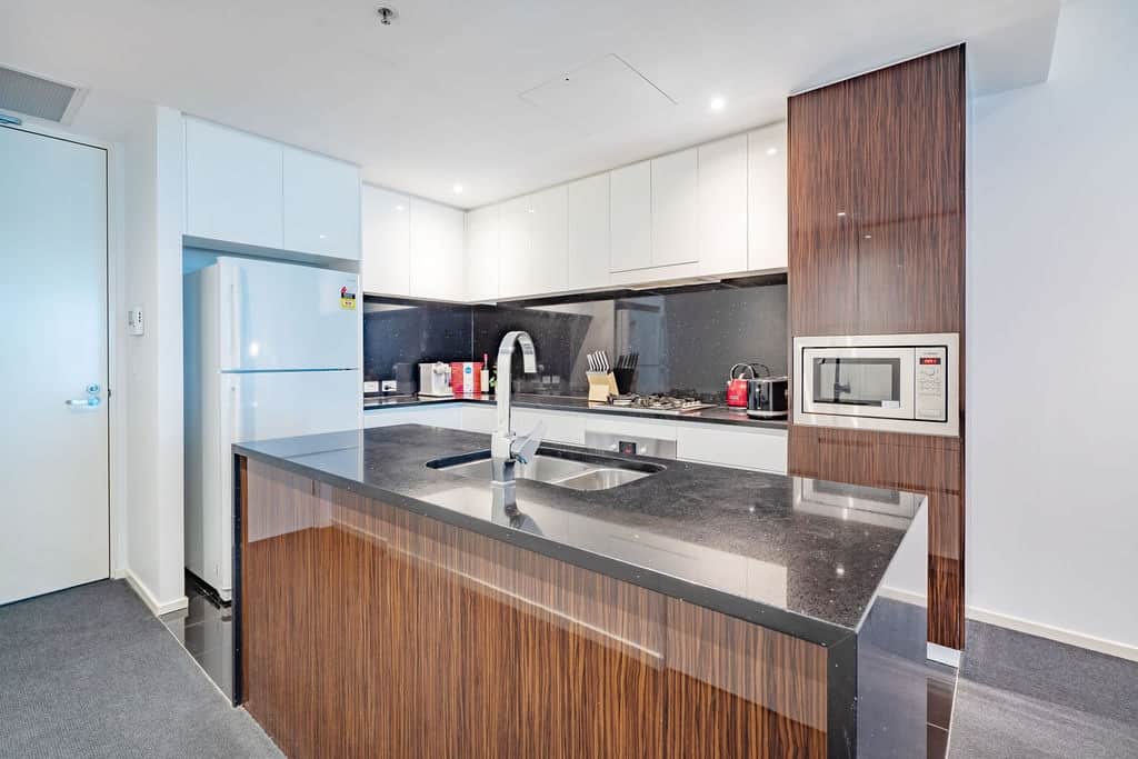 Modern kitchen with stone benchtop plus large fridge for family use.

Appliances includes oven, microwave, and Dishawasher

Small appliances include kettle, toaster and Nespresso machine.

Free pods sample provided.