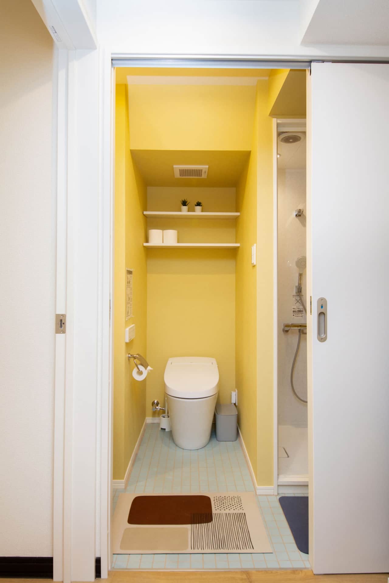 Modern washlet toilet with handy shelves and sink.