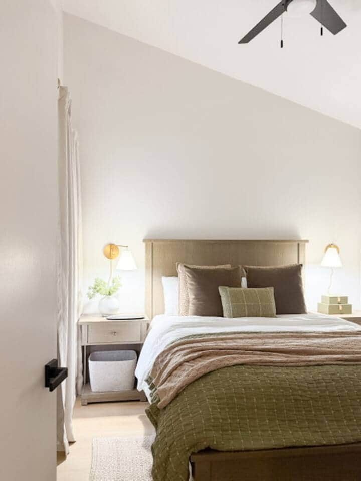 Queen bed with charging ports in nightstands featuring a 55" Smart TV, dresser, and oversized closet.