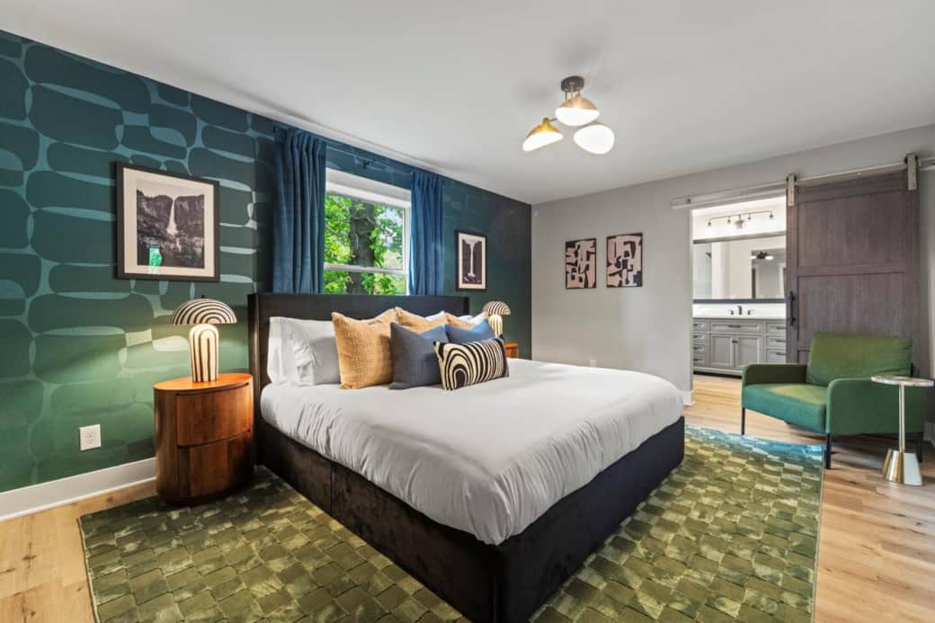 PRIMARY SUITE: King bed, 50” TV, en-suite walk-in shower, large closet with hangers & luggage stand.