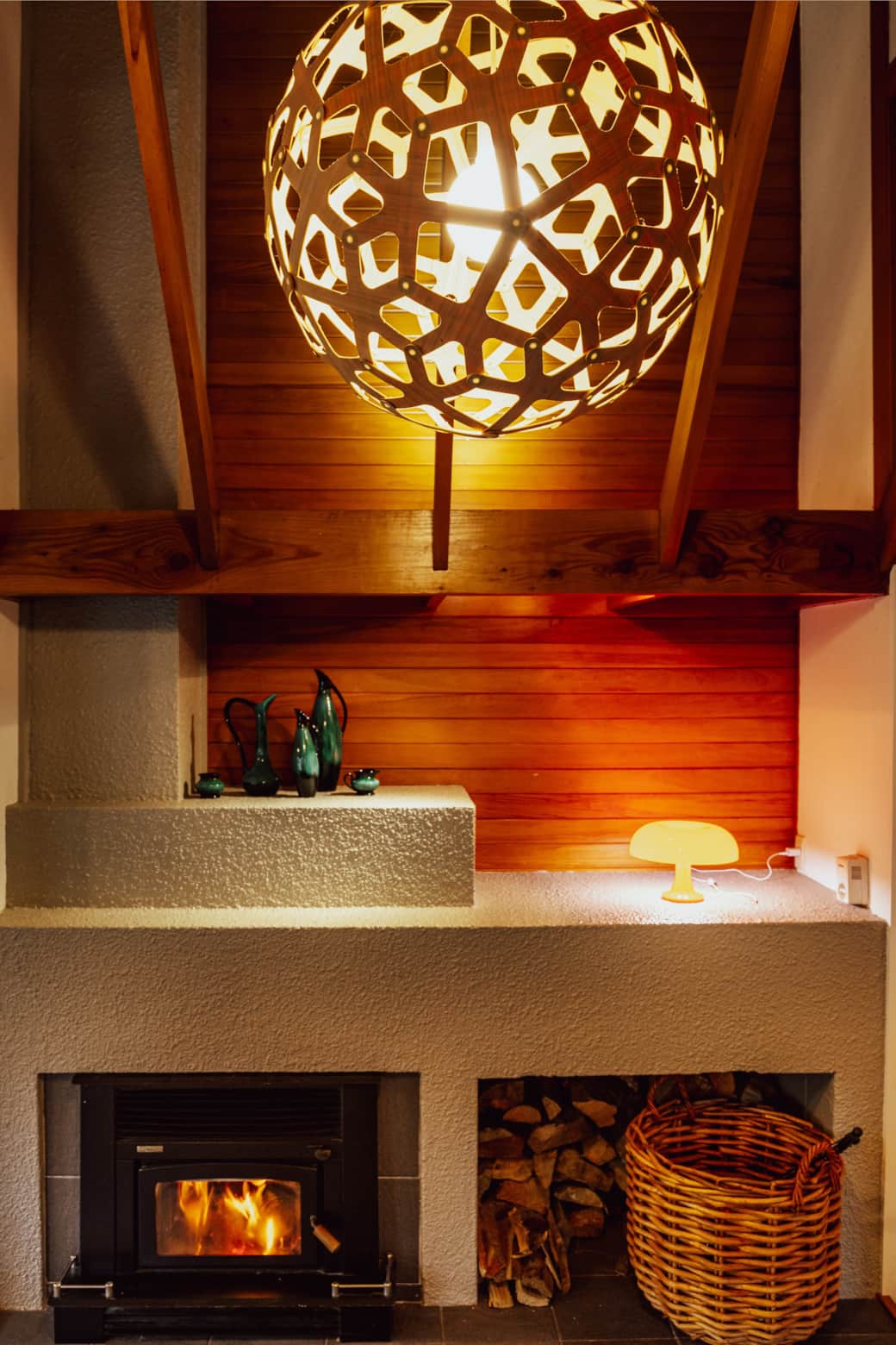 Kiwi pottery and a retro lamp add vintage charm atop the fireplace at Seventeen On Cheltenham.