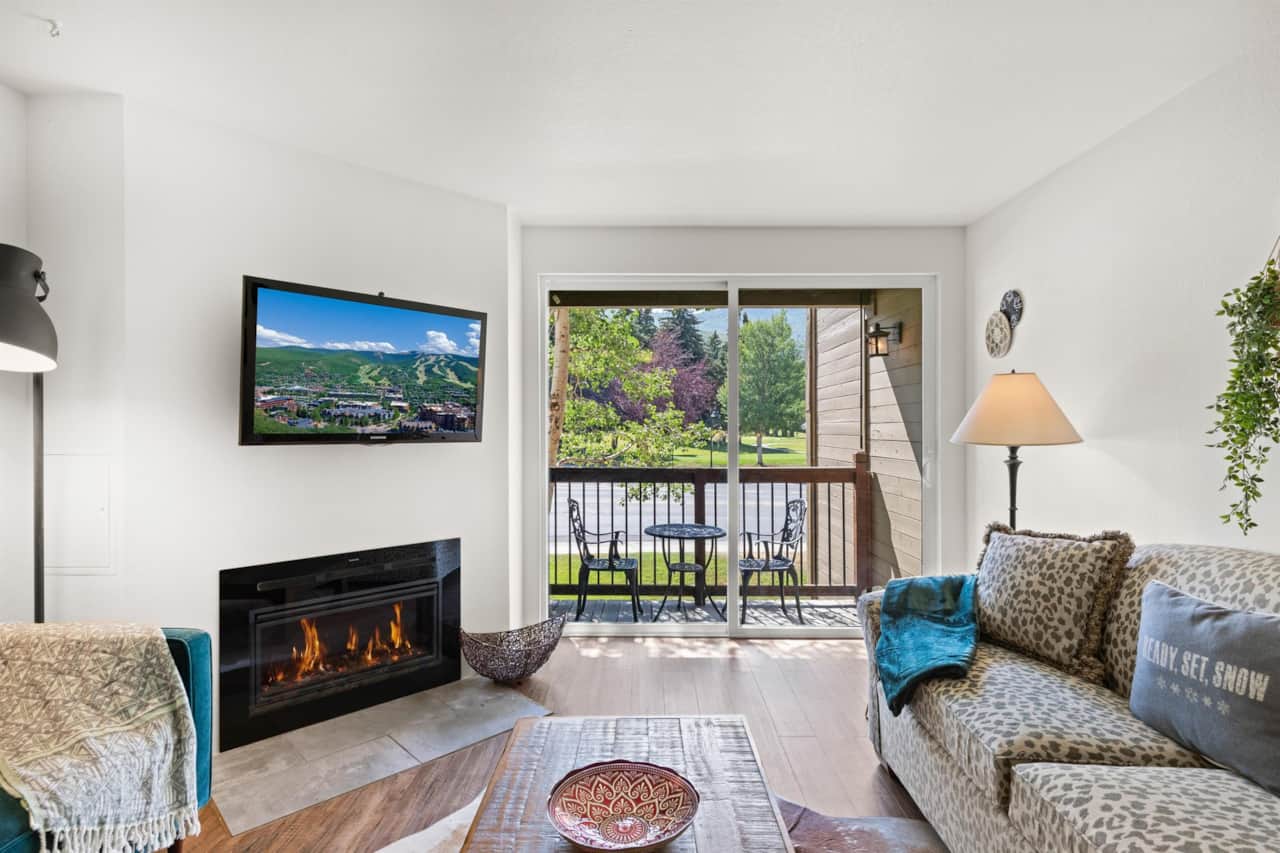 Living room with fireplace and balcony