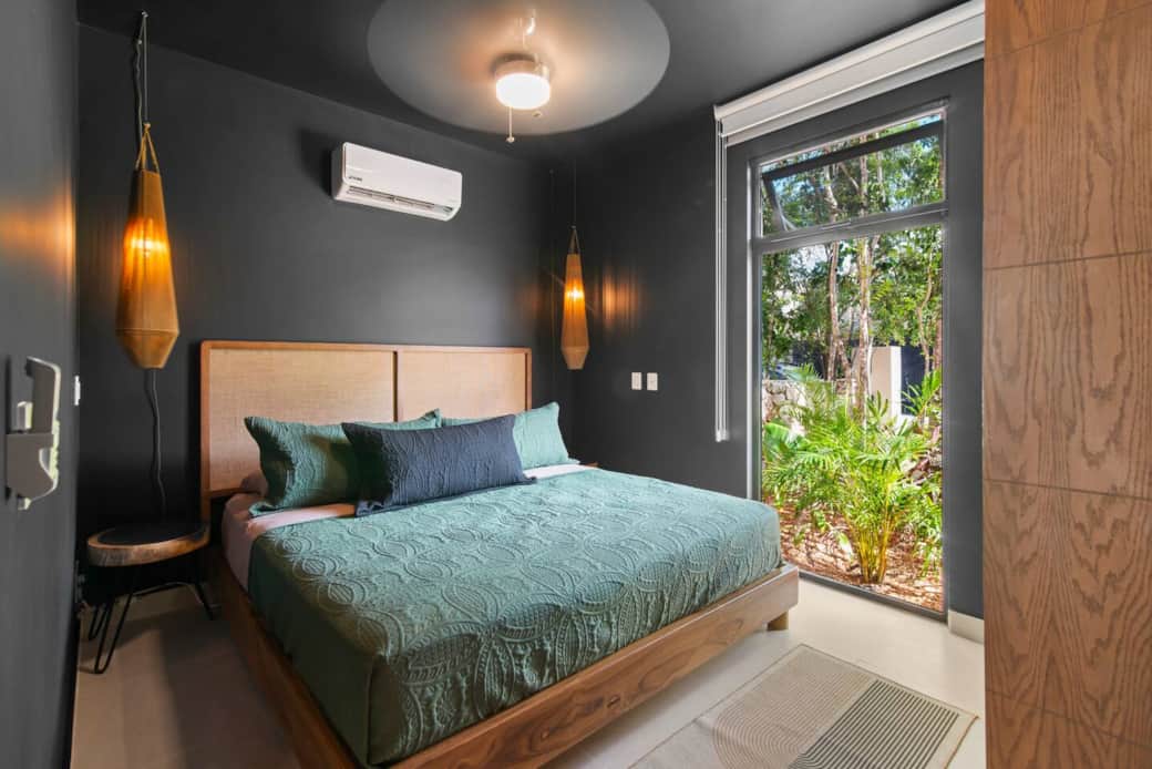 Cozy bedroom with a king-size bed, bedside lamps, and easy-access light switches and outlets. Enjoy A/C, a ceiling fan, and room-darkening shades for a relaxing stay.