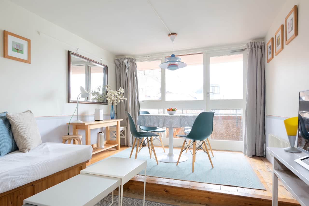 A sunny corner with dining table for four and comfortable daybed seating