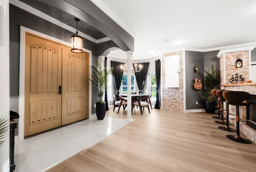 Open-concept entry with poker nook, dartboard wall, and bar with cozy fireplace seating. Open-concept entry with poker nook, dartboard wall, and bar with cozy fireplace seating.