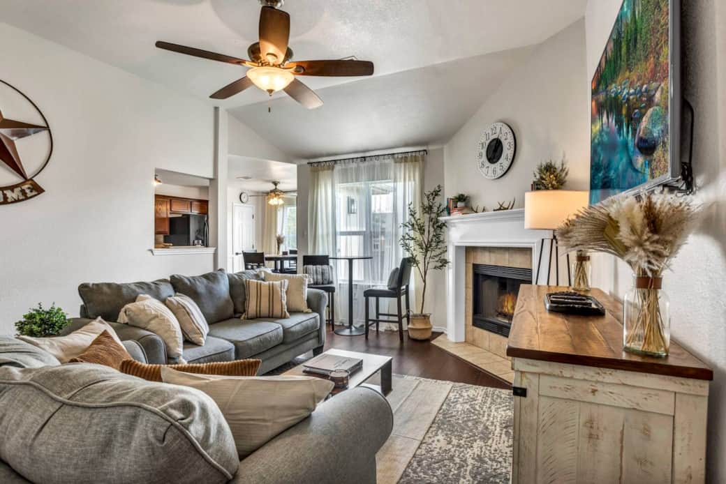 Cozy living room equipped with extra seating and a fully functional wood fireplace. Cozy living room equipped with extra seating and a fully functional wood fireplace.