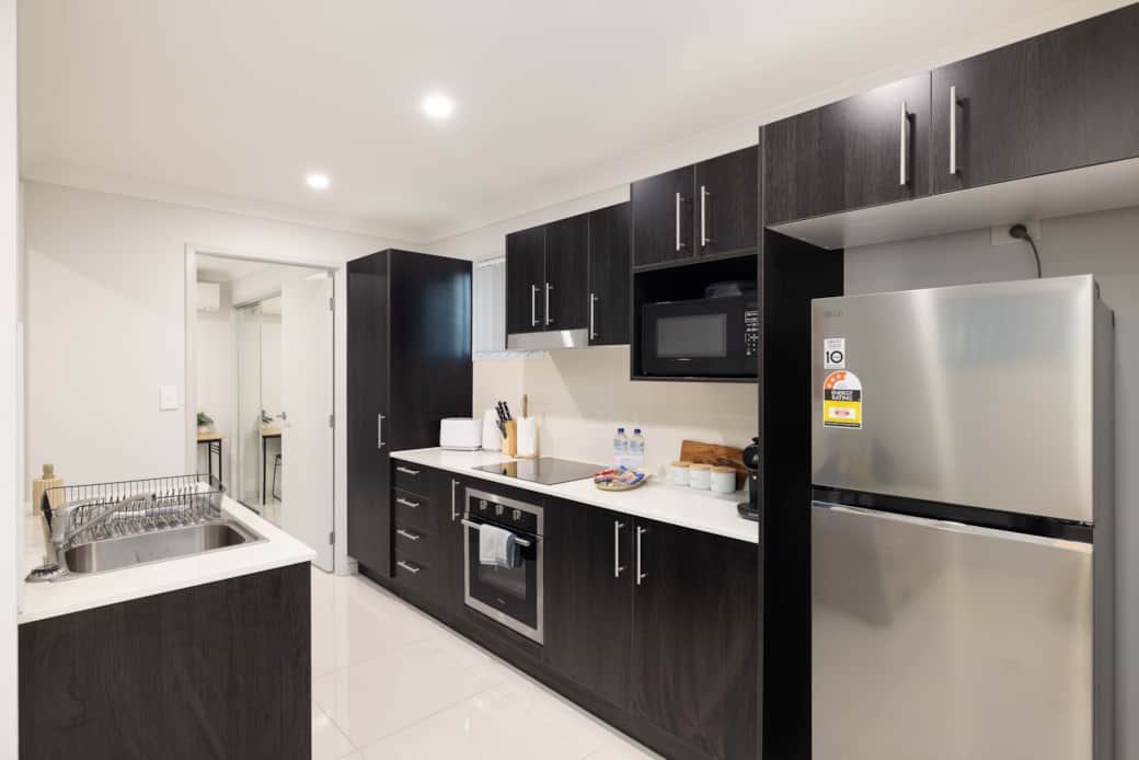 Kitchen: Sleek kitchen with ample storage, modern appliances 