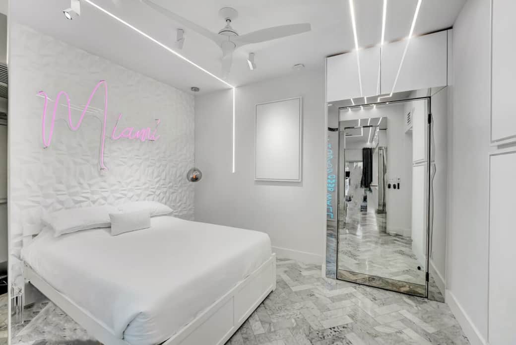 1st FLOOR: THIRD BEDROOM features 1 queen + twin XL pullout trundle bed (sleeps 3). This room also features 2 custom neon signs. Hidden sliding mirrored door separates bedroom from living room / party lounge. Connected bathroom. Kohler fixtures. 