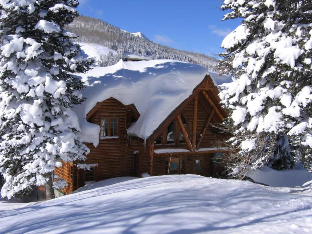 View of home mid winter from the forest in the front View of home mid winter from the forest in the front