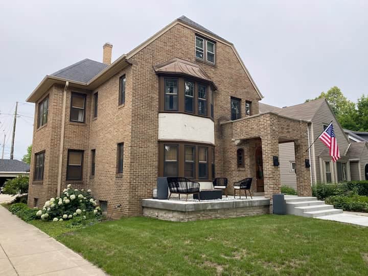 Beautiful brick home with classic architectural details and a welcoming front patio.