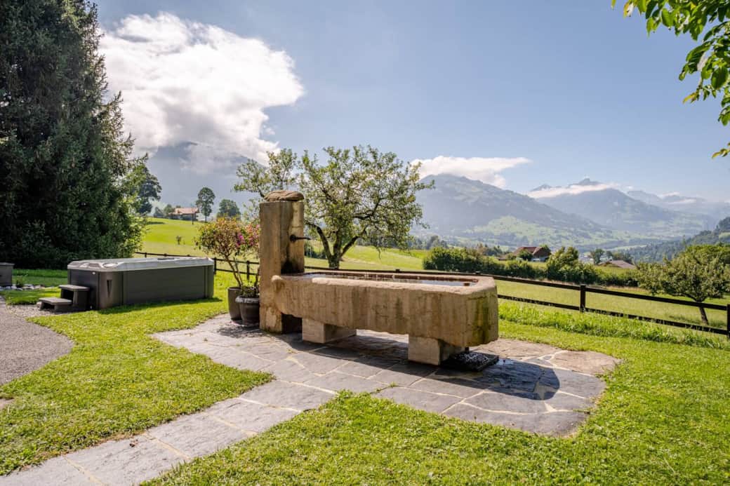 Our front yard features a large stone fountain with potable water, ideal for refreshing dips on warm days. Enjoy breathtaking mountain views, relax in the whirlpool, or unwind under the shade of our large walnut tree on extra outdoor furniture.