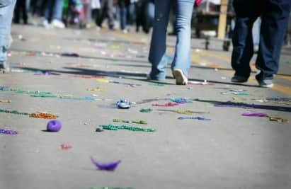 Mardi Gras parade floats rolling down The Strand in Galveston with families catching beads