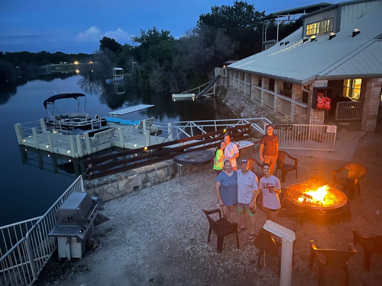 Sunset over the large firepit with seating at the 35-bed Lake Godstone lodge family reunion     