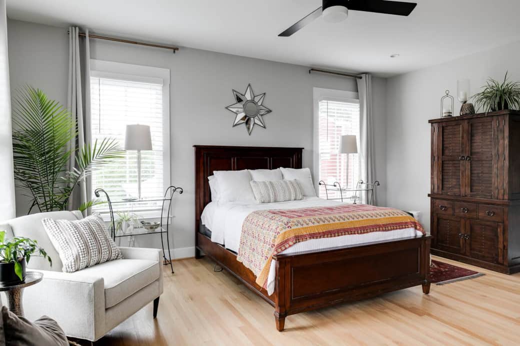 Spacious light-filled master suite with wall mounted smart TV.