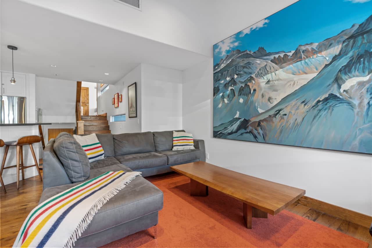 Large living area with fun custom mountain art