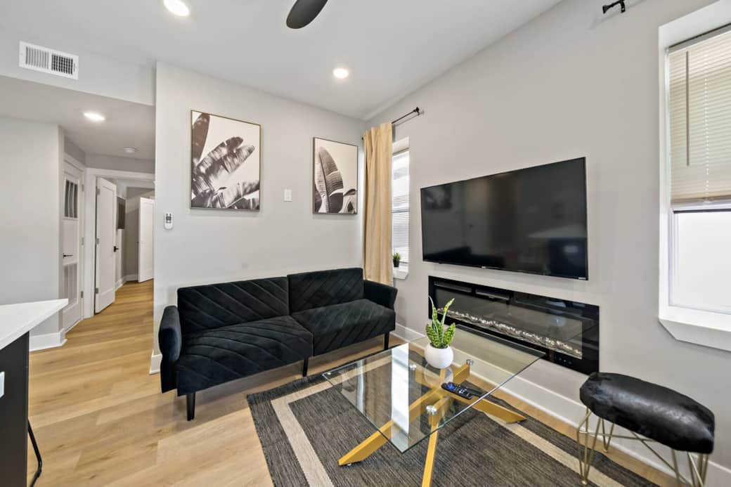 Welcome to our stylish modern living room! Enjoy two cozy sofa beds, a fireplace, and a large flat-screen TV with Ruko, Apple TV, and Netflix. Stay connected with complimentary WiFi and relax with Boardwalk and ocean views.
