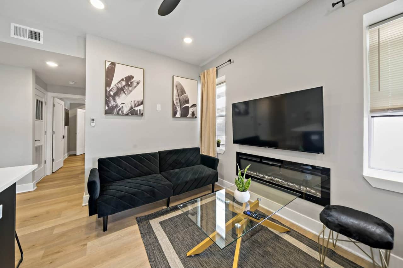 Welcome to our stylish modern living room! Enjoy two cozy sofa beds, a fireplace, and a large flat-screen TV with Ruko, Apple TV, and Netflix. Stay connected with complimentary WiFi and relax with Boardwalk and ocean views.