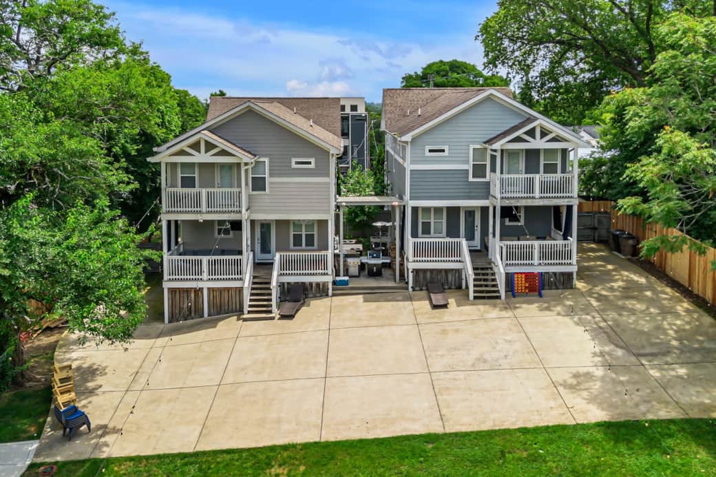 Massive Parking Pad for 6 cars per house - driveway wraps around to exits with auto electronic gates